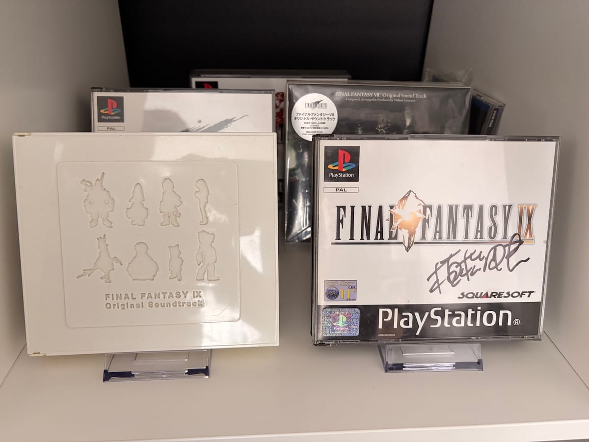 A image of some playstation 1 games. Final Fantasy 9 and the soundtrack boxes are at the front. One box has been signed.